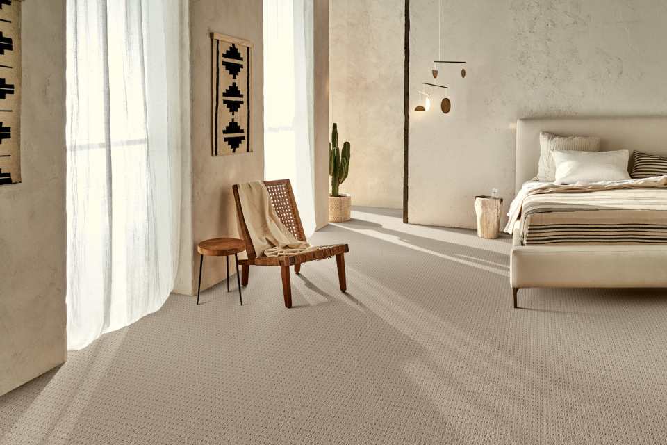textured beige carpet in modern bedroom with limewash walls and neutral tones